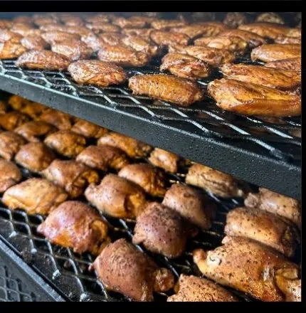 Racks of pickle-brined smoked chicken wings in the smoker